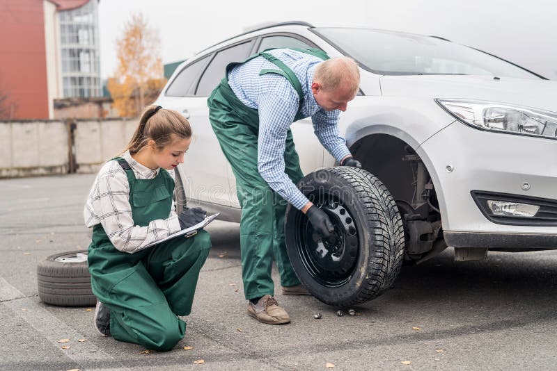 Mechanics Changing Wheel of a Car at Service Stock Image Image of