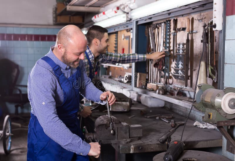 Mechanics at Work in Repair Shop Stock Image Image of indoors