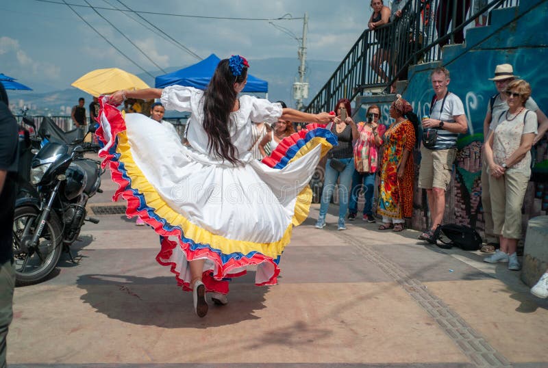 Woman Dancing and Using a White Dress with the Colors of the Colombian Flag