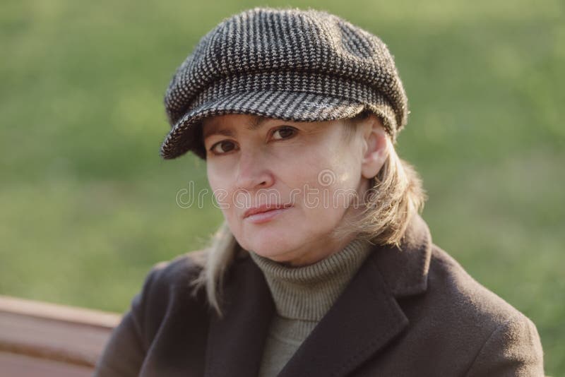 Middle age woman in warm coat and hat outdoors. Middle age woman in warm coat and hat outdoors