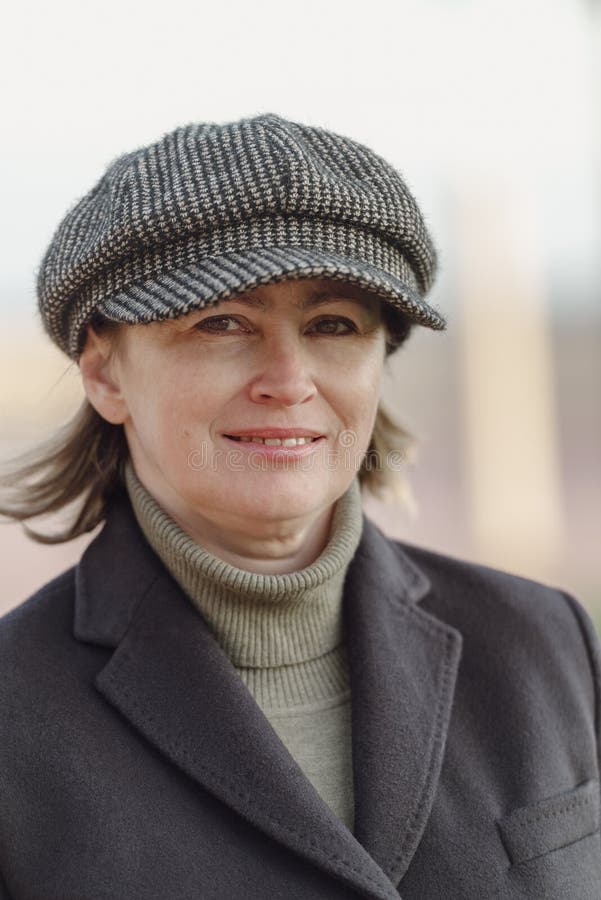 Middle age woman in warm coat and hat outdoors. Middle age woman in warm coat and hat outdoors