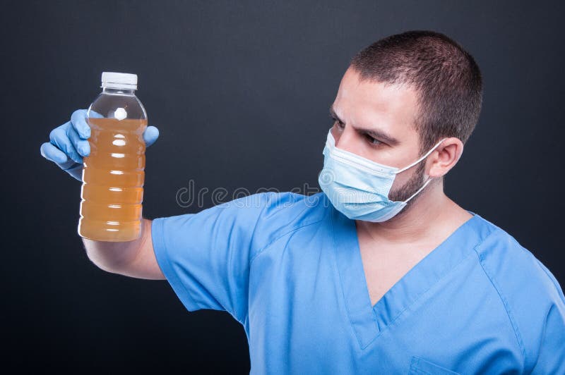 Medic wearing face mask holding not drinkable water royalty free stock images