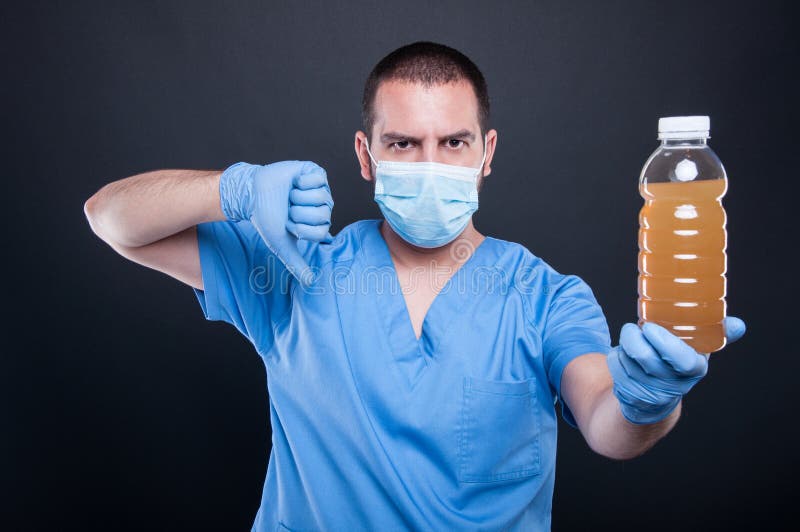 Medic wearing face mask showing polluted water and dislike stock image