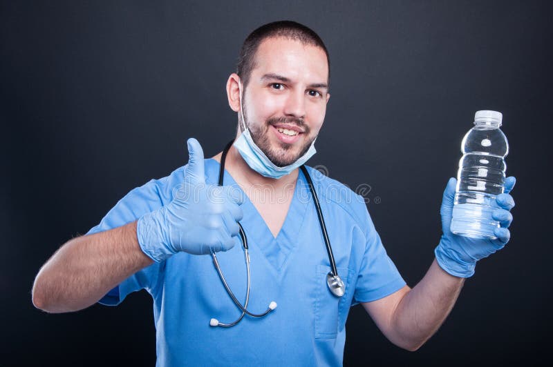 Medic wearing scrubs showing water and like gesture royalty free stock photography