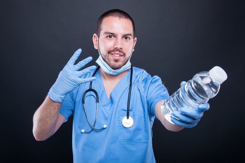Medic wearing scrubs showing water and number four royalty free stock photos