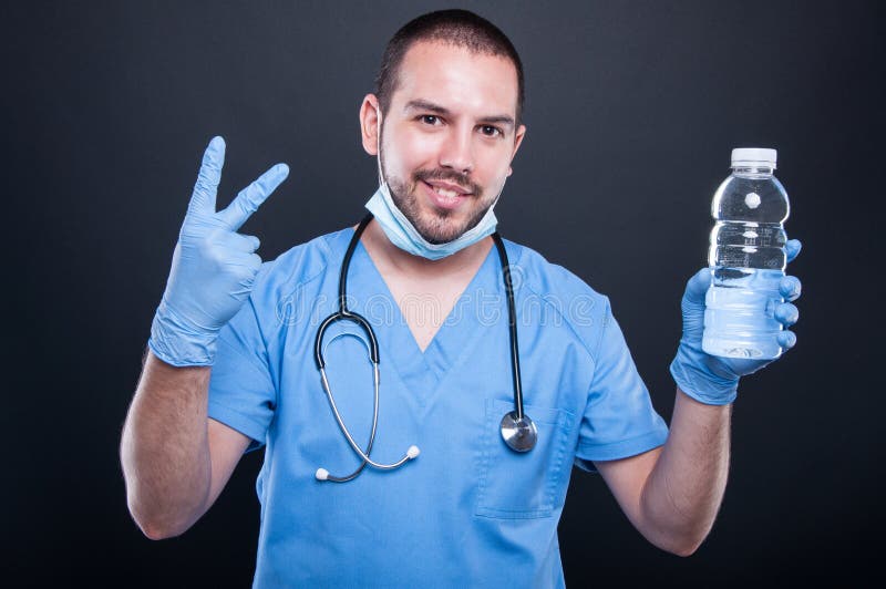 Medic wearing scrubs showing water and number two stock photo