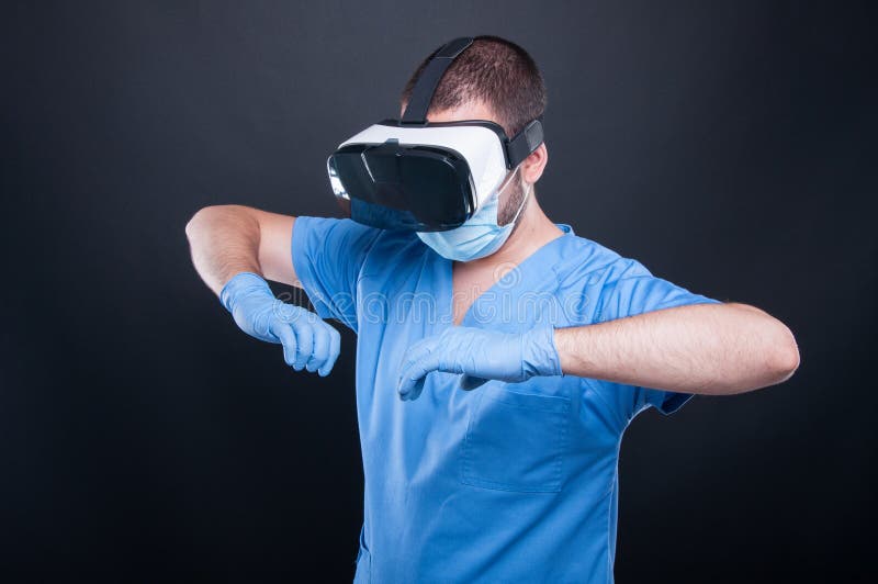Medic wearing scrubs using virtual reality glasses royalty free stock image