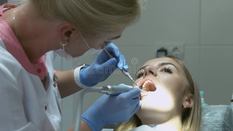 Medical dentist procedure of teeth polishing with cleaning from dental deposit and odontolith stock images Medical dentist procedure of teeth polishing with cleaning from dental deposit and odontolith stock images