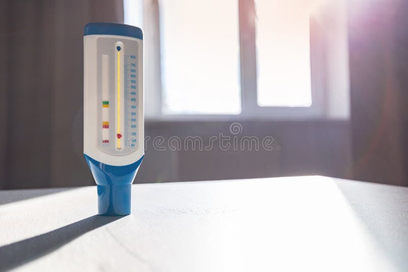 Medical device peak flow meter on wooden table. Copy space, healthy concept stock photo