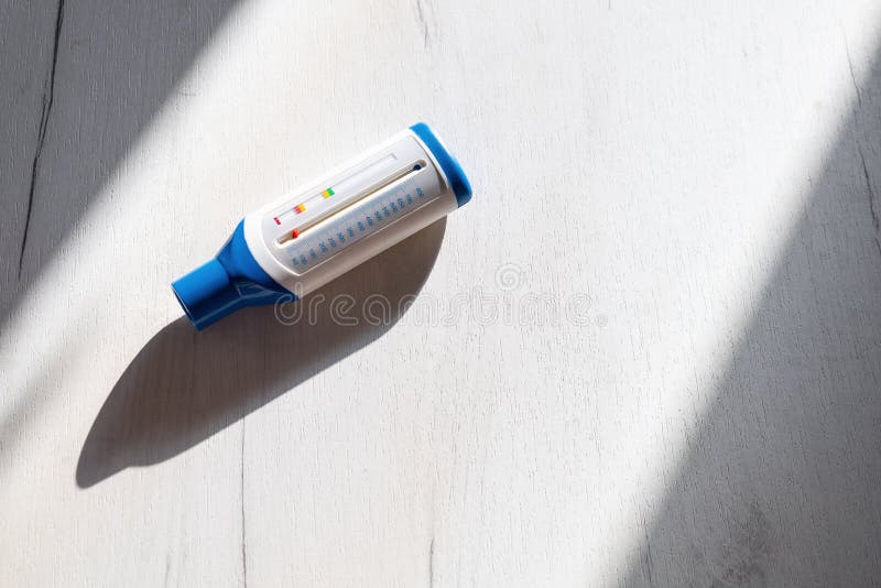 Medical device peak flow meter on wooden table. Copy space, healthy concept royalty free stock image