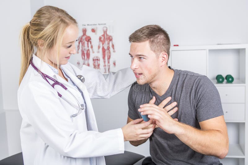 Medical doctor applying oxygen treatment on a sporty men stock photos Medical doctor applying oxygen treatment on a sporty men stock photos