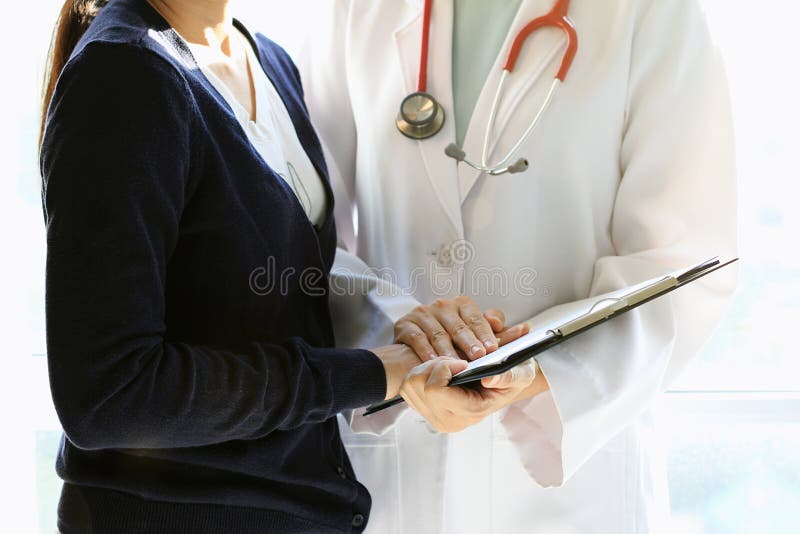 Medical doctor discusses with patient about the health examination results, Worried patient with her doctor in medical office. royalty free stock images Medical doctor discusses with patient about the health examination results, Worried patient with her doctor in medical office. royalty free stock images