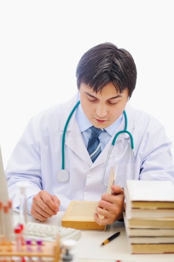Medical doctor studying books stock image