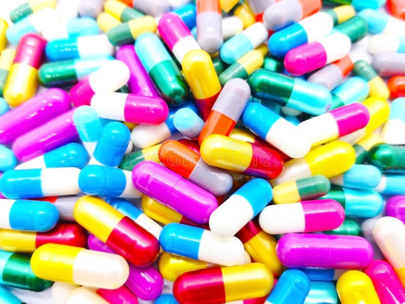 Medical and healthcare concept. Many colorful capsules of Antibiotic drug, that are on white background. Full frame, selective stock image Medical and healthcare concept. Many colorful capsules of Antibiotic drug, that are on white background. Full frame, selective stock image