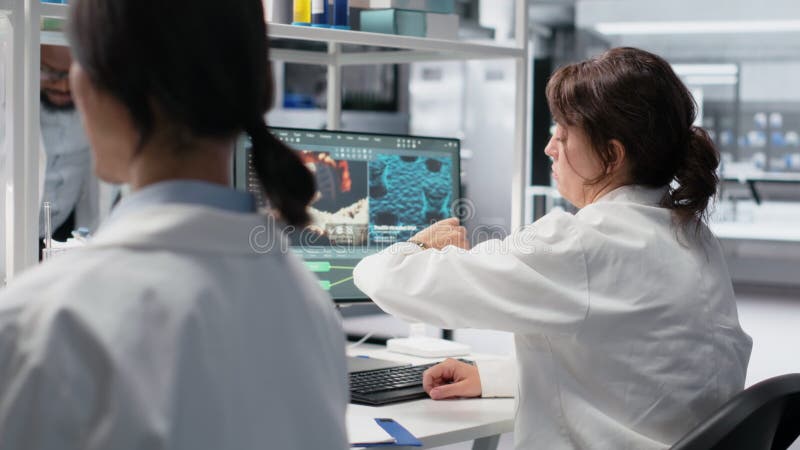 Medical laboratory technician checking time, waiting to finish shift stock footage