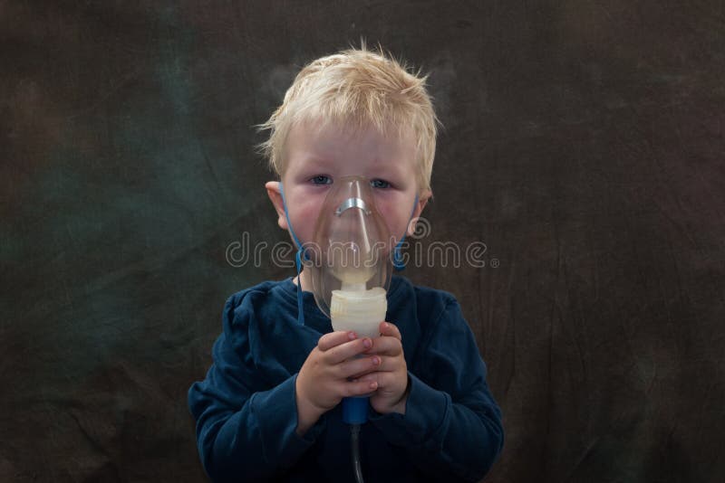 Medical procedures. Inhaler. The Caucasian blonde inhales couples containing medication to stop coughing. The concept of home trea stock image Medical procedures. Inhaler. The Caucasian blonde inhales couples containing medication to stop coughing. The concept of home trea stock image