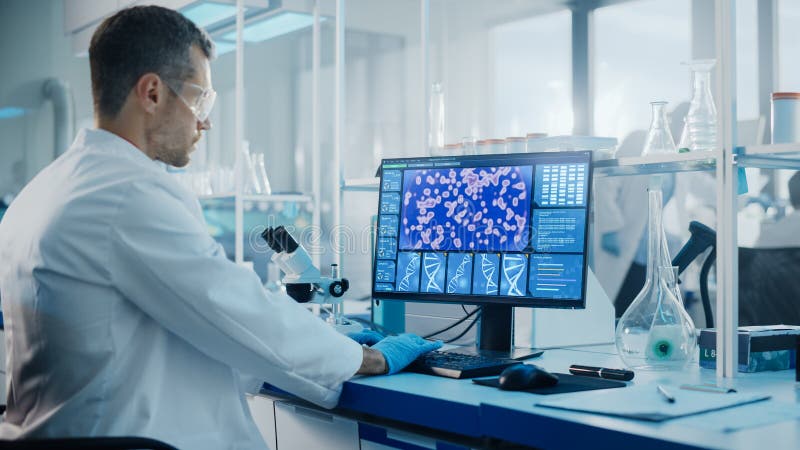 Medical Science Laboratory with Diverse Multi-Ethnic Team of Biotechnology Scientists Developing Drugs, Microbiologist Working on Computer with Display Showing Gene Editing Interface. Diverse medical team stock images, royalty-free photos and pictures