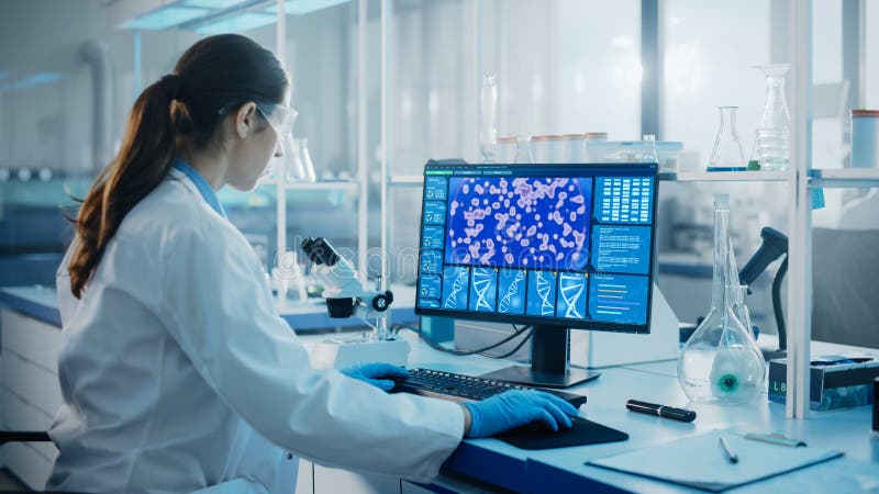 Medical Science Laboratory with Diverse Multi-Ethnic Team of Biotechnology Scientists Developing Drugs, Microbiologist Working on Computer with Display Showing Gene Editing Interface. Diverse medical team stock images, royalty-free photos and pictures