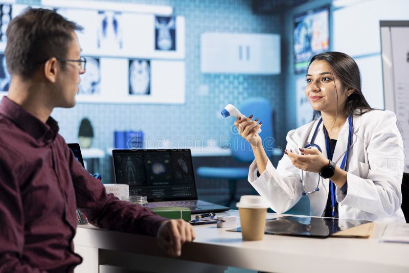 Medical specialist using thermometer to check fever measurements stock images
