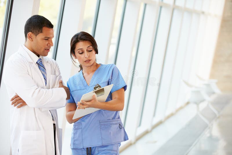 Medical Staff Having Discussion In Modern Hospital Corridor royalty free stock images