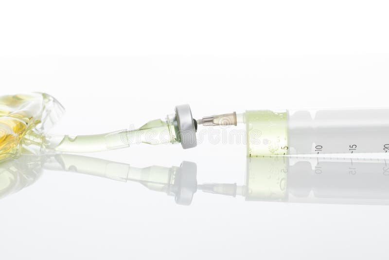 Medical Syringe Connected To Container with Medication Close Up Studio Shot Stock Photo