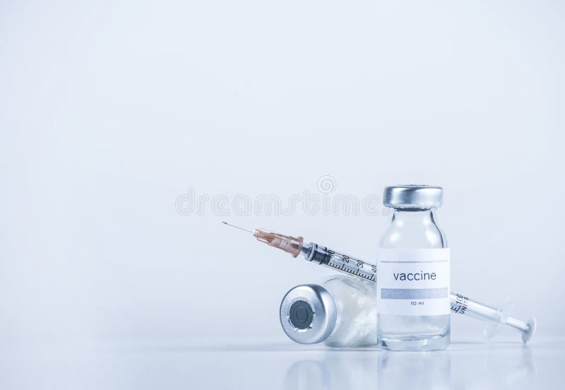 Medical tube with medicine and with the inscription Vaccine and syringe close-up. Copy space. Vaccine concept