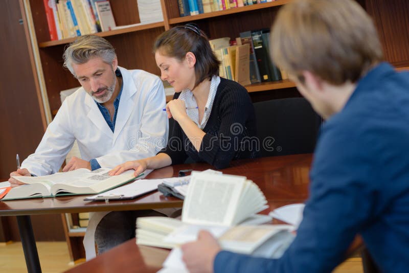Medical workers in library stock photo
