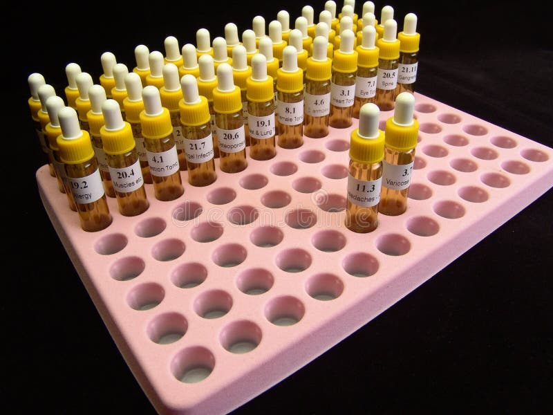 Phials of homoeopathic drugs arranged in row and column in a plastic packaging and holding system for use in hospitals and drug stores. Phials of homoeopathic drugs arranged in row and column in a plastic packaging and holding system for use in hospitals and drug stores