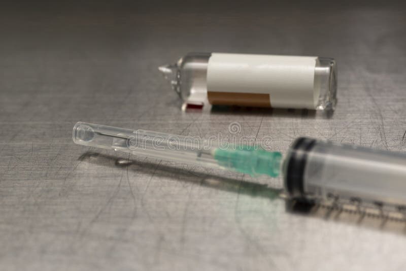 Medication in a syringe and broken vial royalty free stock photo Medication in a syringe and broken vial royalty free stock photo