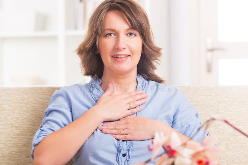 Woman practicing self Reiki transfering energy through palms, a kind of energy medicine. Woman practicing self Reiki transfering energy through palms, a kind of energy medicine.