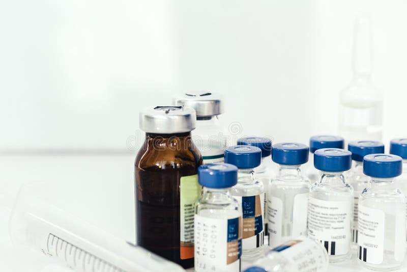 Medicine bottles, ampules, on white background with copy space for text, treatment medication concept closeup