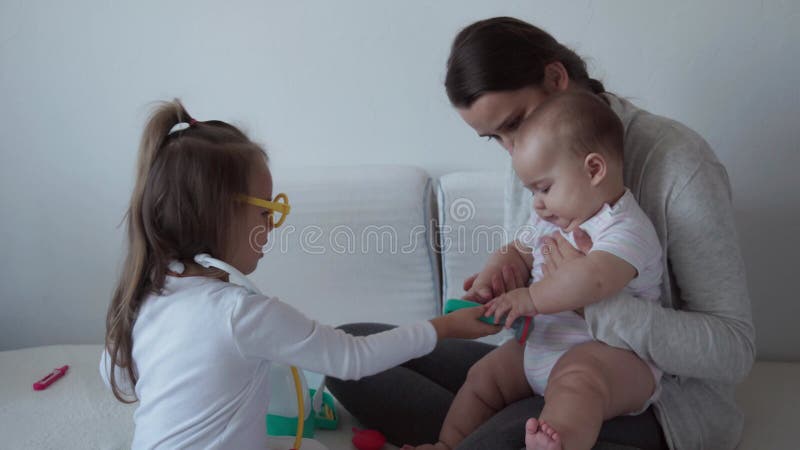 Medicine, family, game concepts - Concentrated playful little kids child wear medical glasses use stethoscope. Pretend