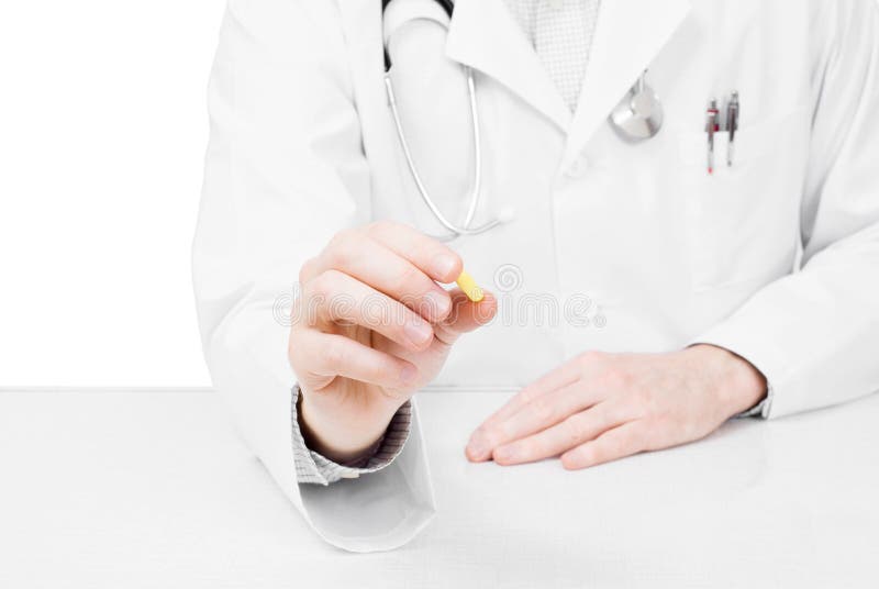 Doctor offering pill - studio shot on white. Doctor offering pill - studio shot on white