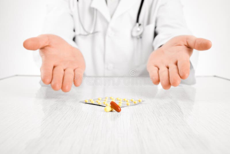 Doctor indicating on pills with two hands isolated on white. Doctor indicating on pills with two hands isolated on white