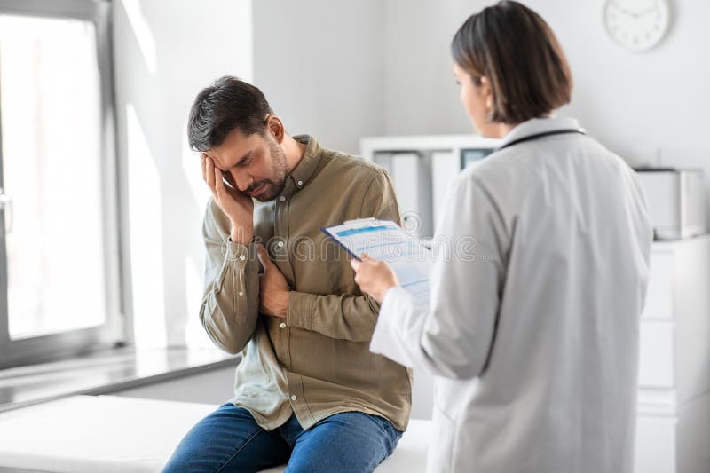Doctor and sad man with health problem at hospital royalty free stock image