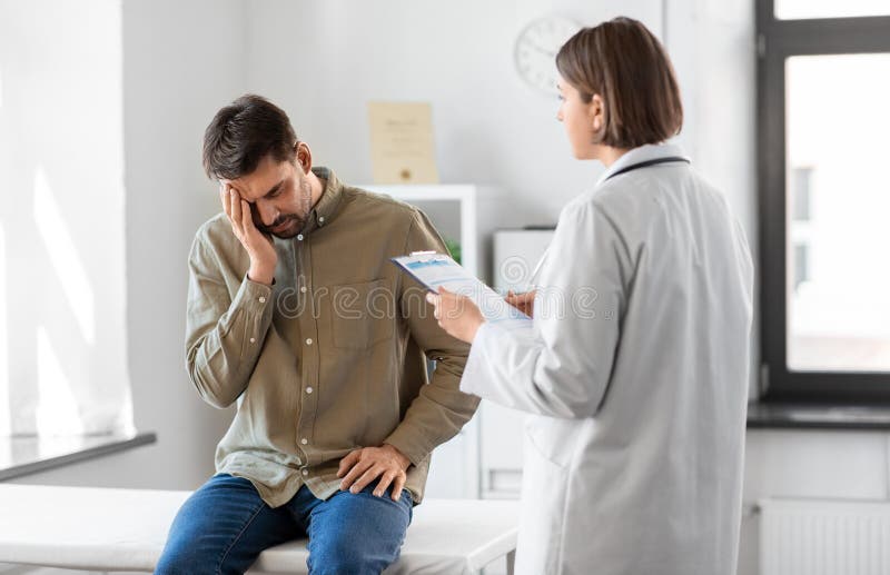Doctor and sad man with health problem at hospital stock images