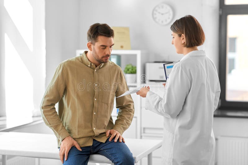 Doctor showing prescription to patient at hospital stock photo