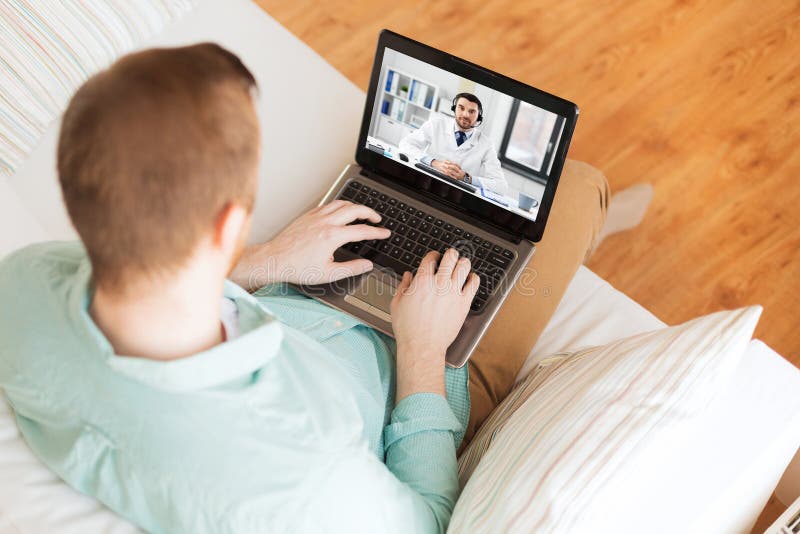 Man having video call with male doctor on laptop stock images Man having video call with male doctor on laptop stock images