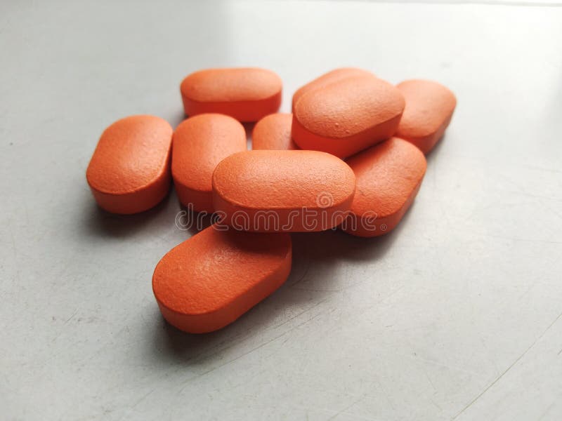 Medicine Tablet in Orange Colour on White Table Stock Photo Image of