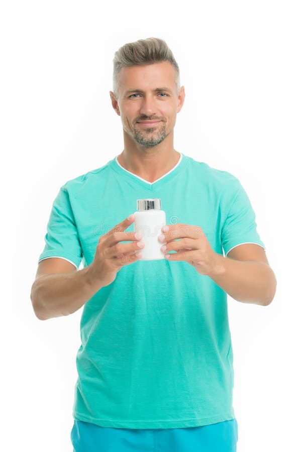 Medicines concept. Health is wealth. Bearded man holding vitamin pill container. Health pill. Mature man with pill royalty free stock photography Medicines concept. Health is wealth. Bearded man holding vitamin pill container. Health pill. Mature man with pill royalty free stock photography