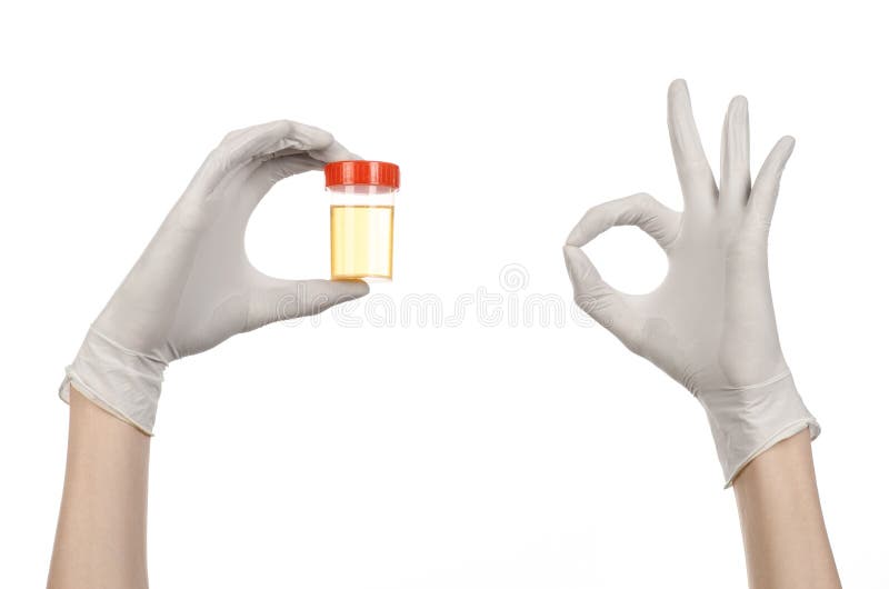 Medical theme: doctor's hand in white gloves holding a transparent container with the analysis of urine on a white background studio. Medical theme: doctor's hand in white gloves holding a transparent container with the analysis of urine on a white background studio