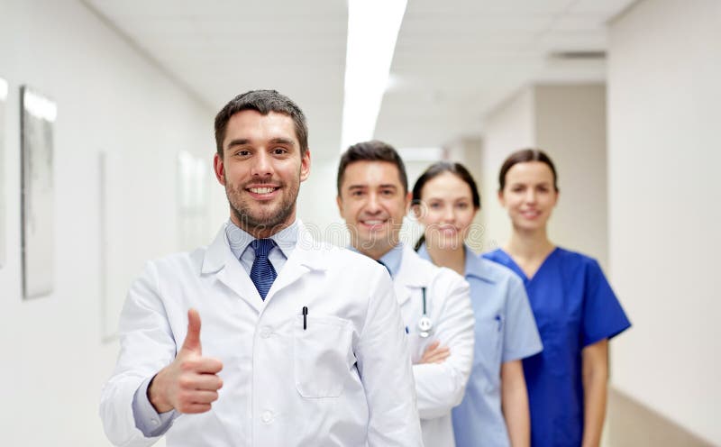 Medics or doctors at hospital showing thumbs up