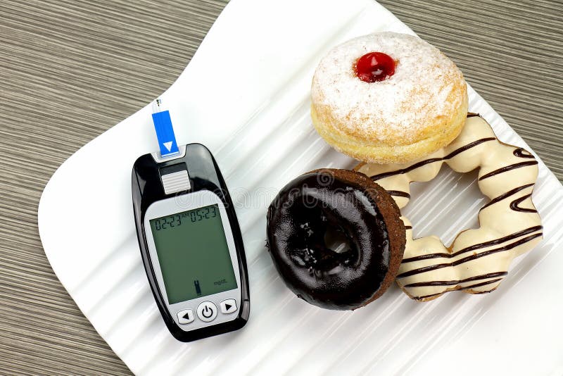 Blood sugar measurement, Diabetic kit, Blood glucose meter test kit. Unhealthy food like donut and confectionery increase sugar in blood. Blood sugar measurement, Diabetic kit, Blood glucose meter test kit. Unhealthy food like donut and confectionery increase sugar in blood.