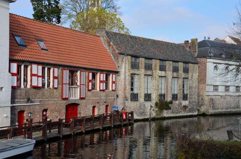 A picturesque row of old brick houses constructed by a canal in the Belgian city of Brugge. A picturesque row of old brick houses constructed by a canal in the Belgian city of Brugge.