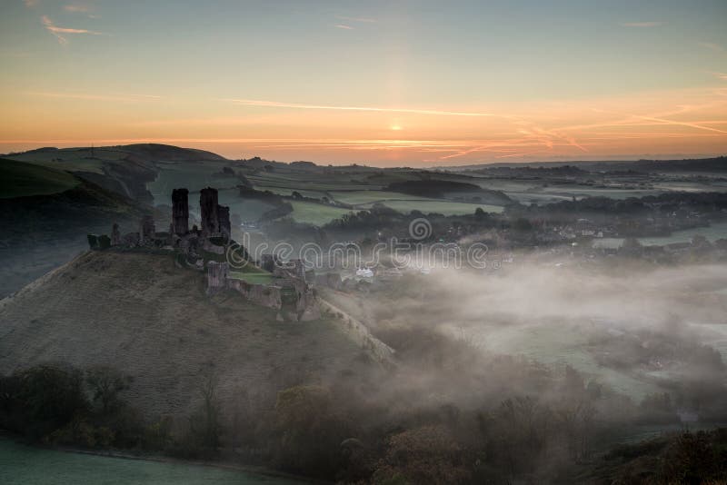Medieval castle ruins with foggy landscape at sunrise. Vibrant sunrise over medieval castle ruins with fog in rural landscape royalty free stock images Medieval castle ruins with foggy landscape at sunrise. Vibrant sunrise over medieval castle ruins with fog in rural landscape royalty free stock images