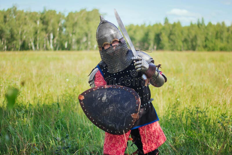 A medieval Central Asian warrior a nomad in 14th-century armor stands in a defensive or attacking position stock photos