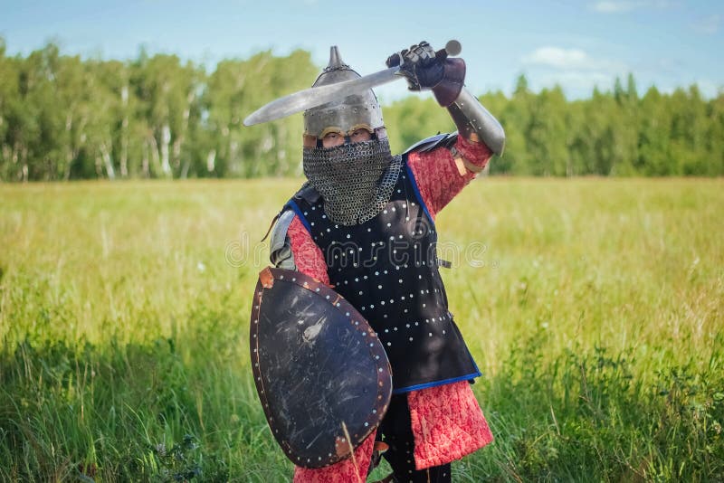 A medieval Central Asian warrior a nomad in 14th-century armor stands in a defensive or attacking position royalty free stock image
