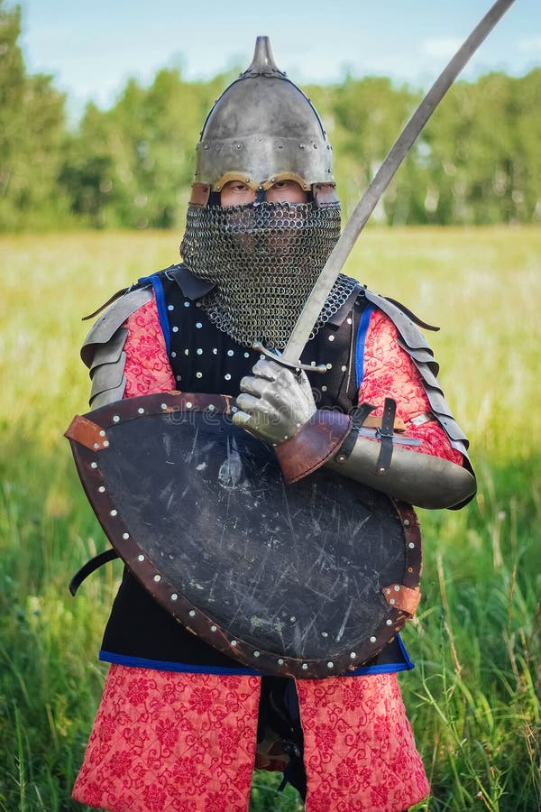 A medieval Central Asian warrior a nomad in 14th-century armor stands in a defensive or attacking position royalty free stock photo