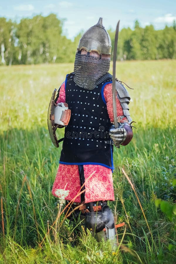 A medieval Central Asian warrior a nomad in 14th-century armor stands in a defensive or attacking position royalty free stock photos