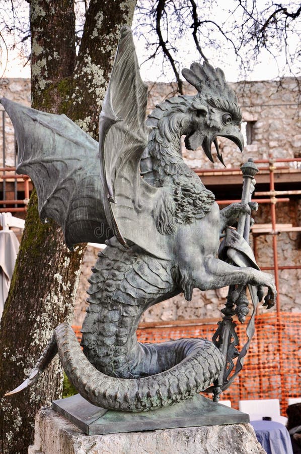 Medieval dragon statue in the castle Gradina,Rijeka city Dragon silhouette closeup in public place. Dragon head and tongue silhouette in old Rijeka public royalty free stock image Medieval dragon statue in the castle Gradina,Rijeka city Dragon silhouette closeup in public place. Dragon head and tongue silhouette in old Rijeka public royalty free stock image
